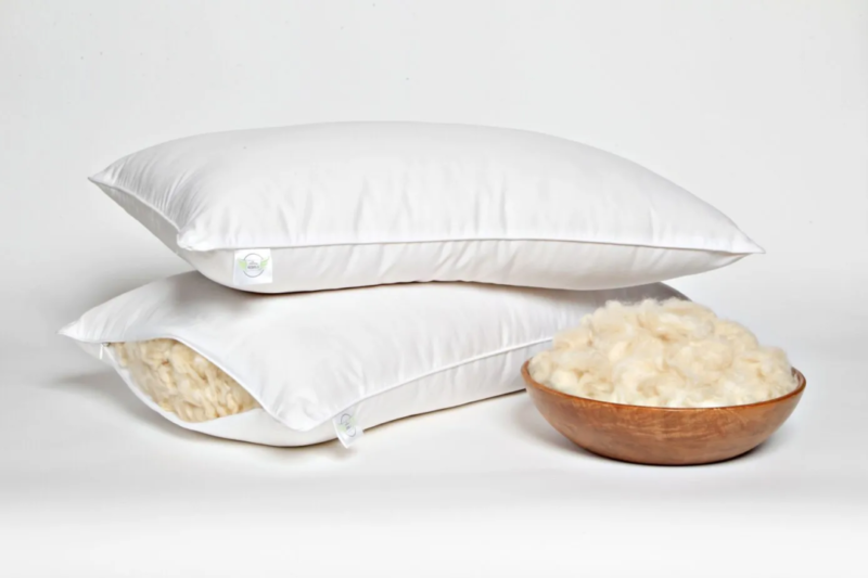 Two white pillows stacked with wool filling